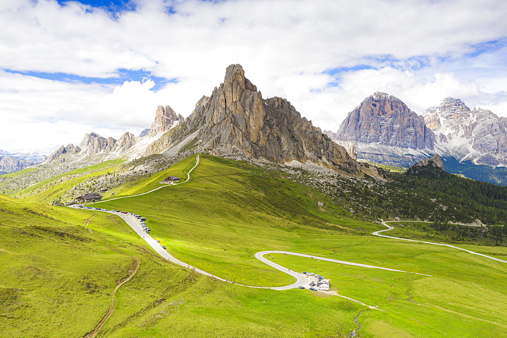 Winding road of Giau Pass in the green landscape with Ra Gusela and Tofane mountains in background, Dolomites, Veneto, Italy, Europe