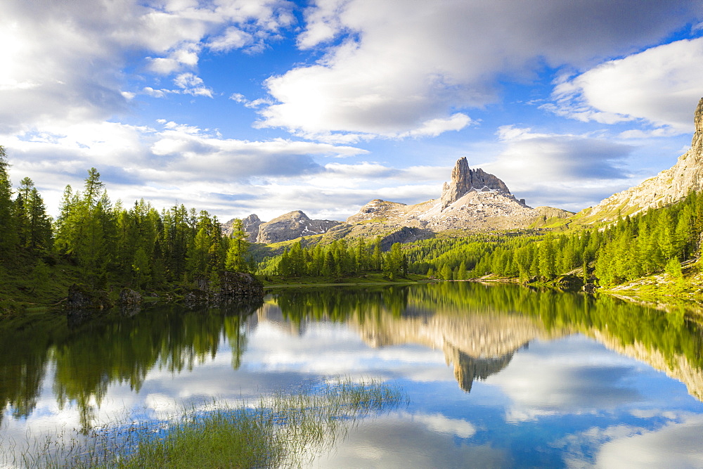 Clouds over Becco di Mezzodi reflected in the blue water of Lake Federa at sunrise, Ampezzo Dolomites, Belluno, Veneto, Italy, Europe