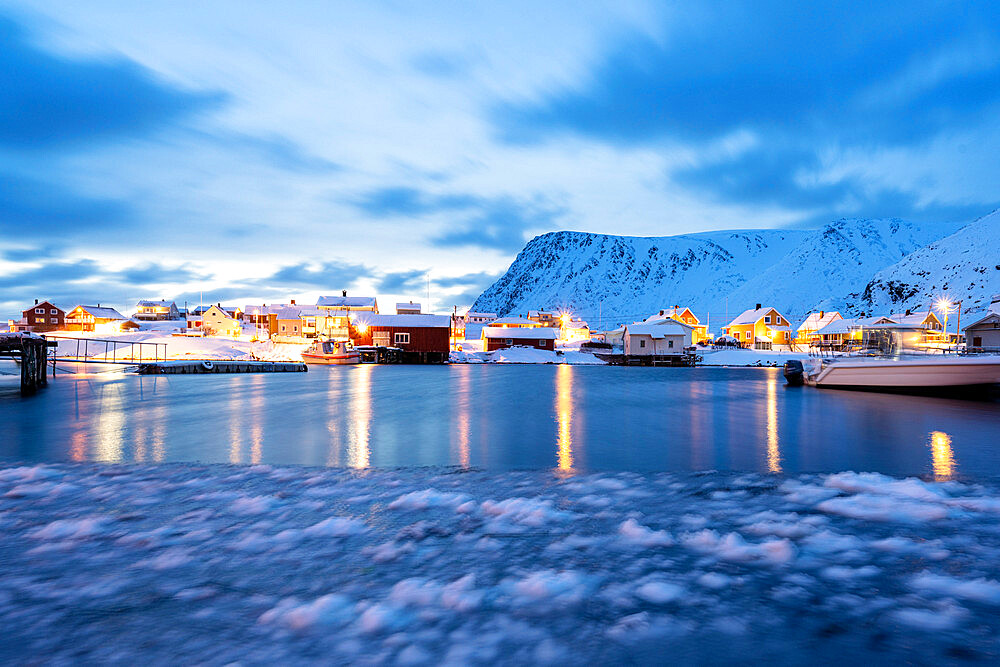 Winter dusk over the frozen sea surrounding the fishing village of Sorvaer, Soroya Island, Troms og Finnmark, Northern Norway, Scandinavia, Europe