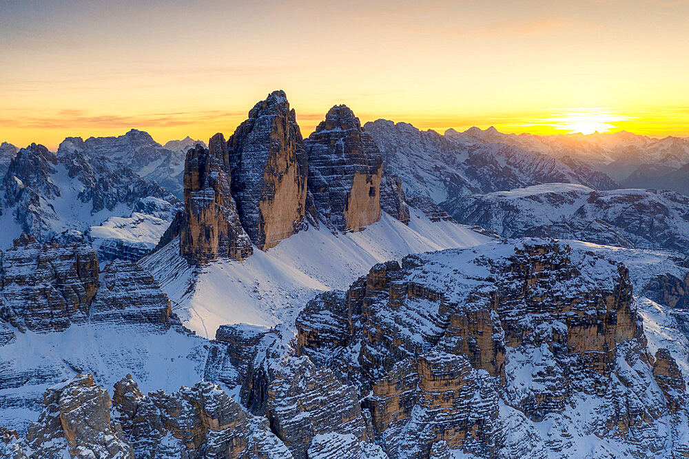 Sunset over Tre Cime Di Lavaredo, Monte Paterno and Cristallo during a snowy autumn, Sesto Dolomites, South Tyrol, Italy, Europe