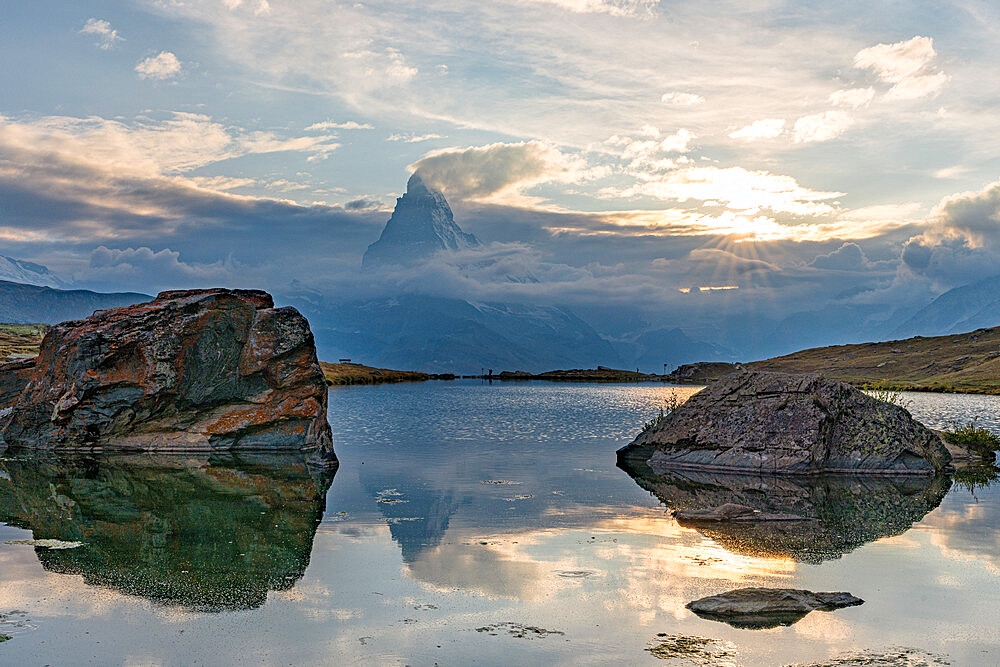 Sunset over Matterhorn peak reflected in lake Stellisee, Zermatt, Valais canton, Switzerland, Europe