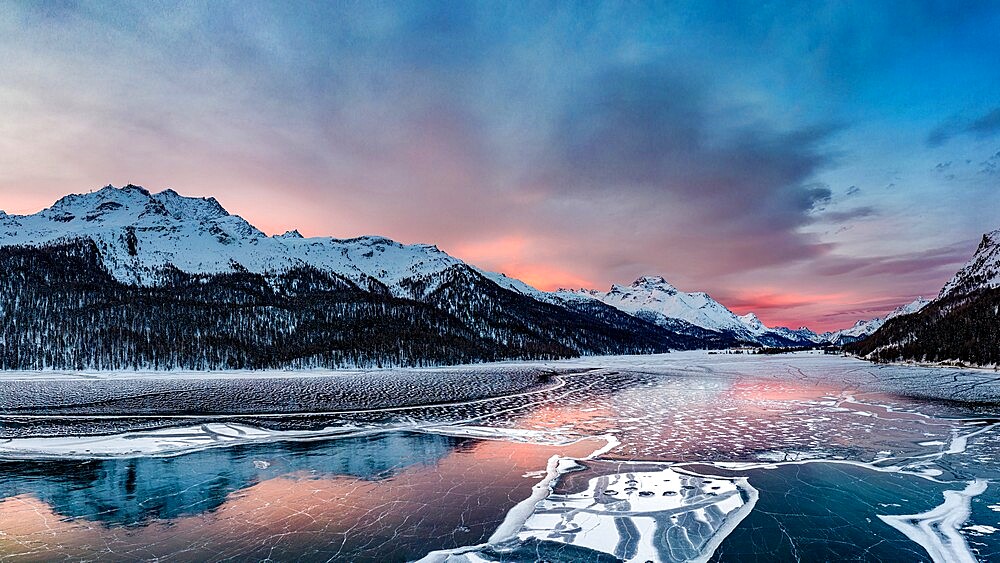 Aerial view of snowcapped mountains and frozen Lake Silvaplana at sunrise, Maloja, Engadine, Graubunden canton, Switzerland, Europe