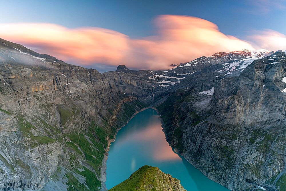 Clouds at sunset over the pristine lake Limmernsee and mountains, aerial view, Canton of Glarus, Switzerland, Europe