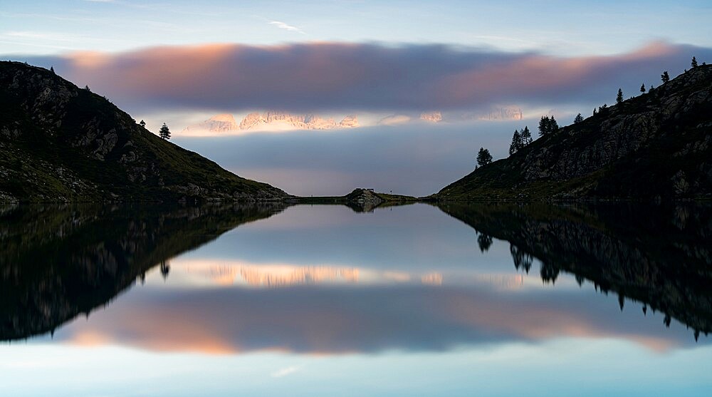 Clouds over Brenta Dolomites and Lake Ritorto at sunset, Madonna di Campiglio, Trento province, Trentino-Alto Adige, Italy, Europe