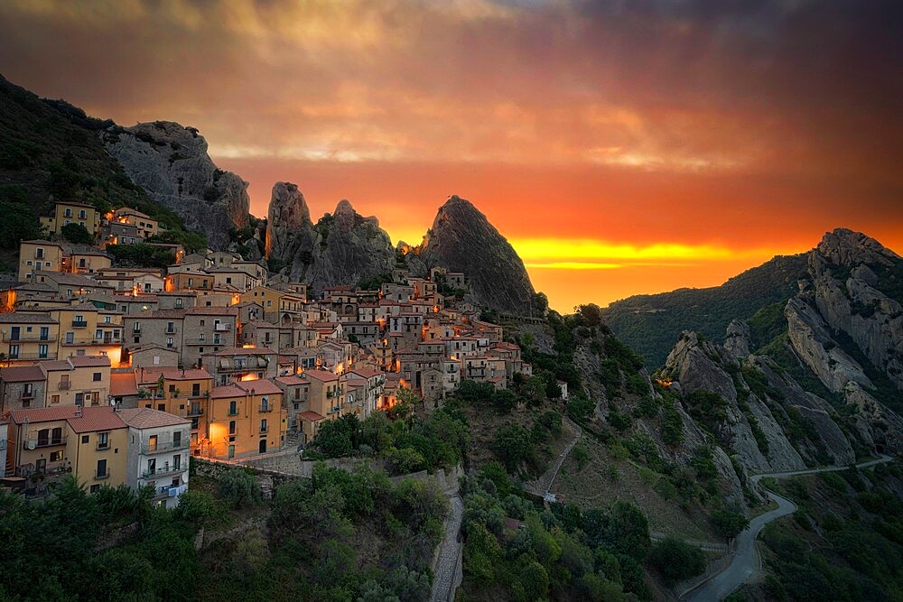 Burning sky at sunrise over the old houses of Castelmezzano and Dolomiti Lucane mountains, Potenza province, Basilicata, Italy, Europe