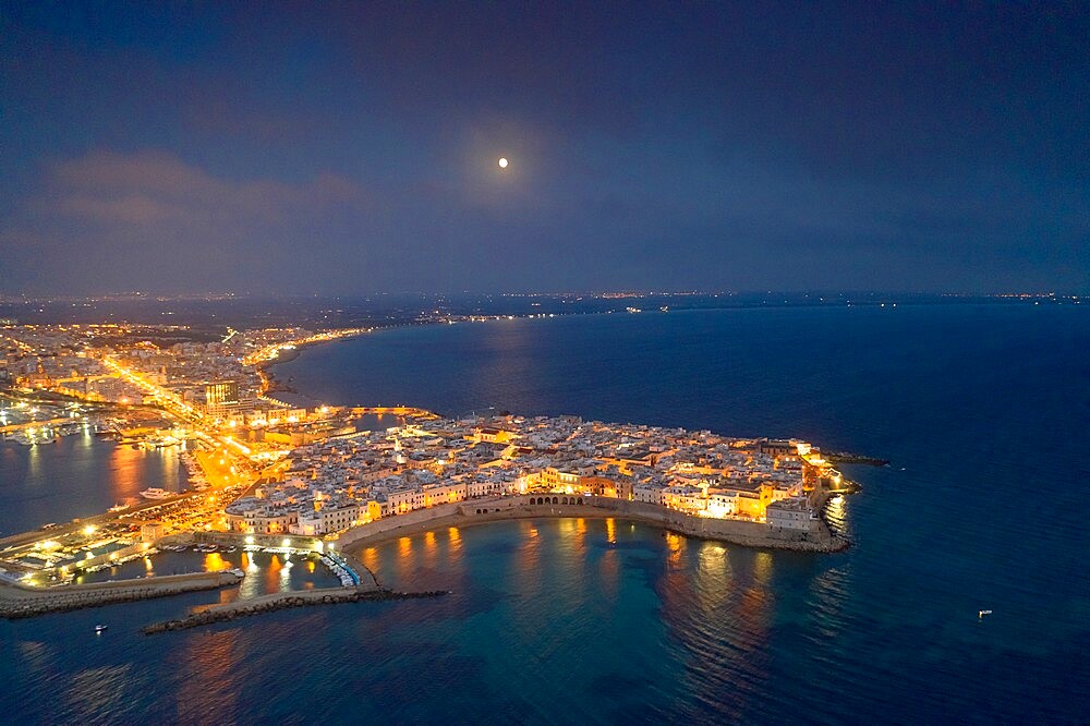 Aerial view of the coastal town of Gallipoli illuminated at night, Lecce province, Salento, Apulia, Italy, Europe