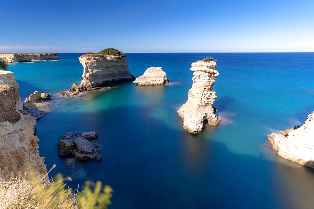 Faraglioni (limestone stacks) of Torre Sant'Andrea in the crystal sea, Lecce province, Salento, Apulia, Italy, Europe