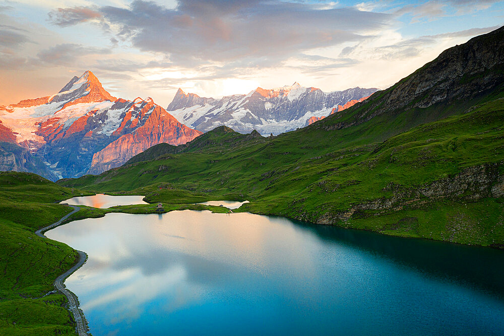 Schreckhorn and Finsteraarhorn peaks reflected in Bachalpsee lake at sunset, Grindelwald, Bernese Oberland, Switzerland, Europe