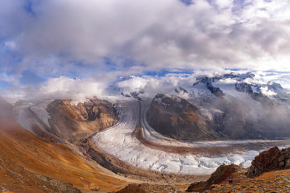 Cloudy sky over snowcapped mountains and Gorner Glacier (Gornergletscher), Zermatt, canton of Valais, Switzerland, Europe