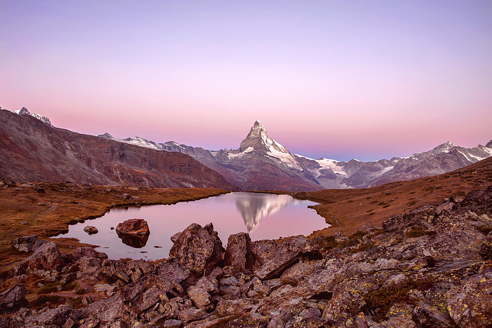 Pink sky at sunrise on the Matterhorn reflected in Stellisee, Zermatt, Canton of Valais, Pennine Alps, Swiss Alps, Switzerland, Europe