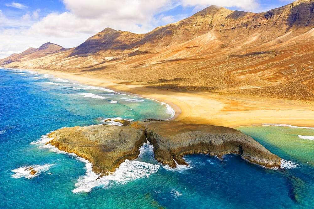 Aerial view of El Islote islet in the crystal ocean along Cofete beach, Jandia, Fuerteventura, Canary Islands, Spain, Atlantic, Europe