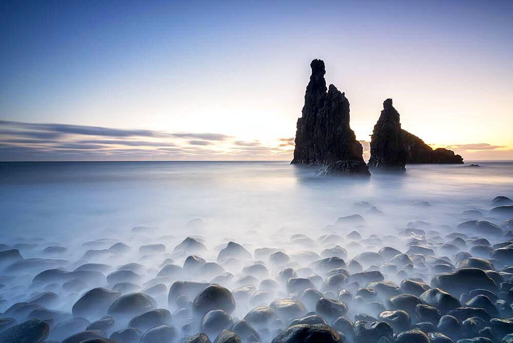 Long exposure of waves crashing on Ilheus da Rib and Ribeira da Janela rock formations at dusk, Madeira island, Portugal, Atlantic, Europe