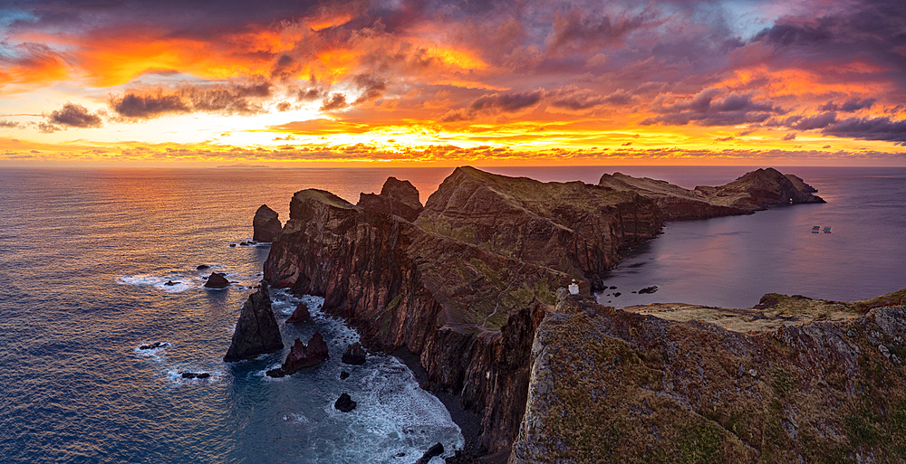 Cliffs by the ocean under the burning sky at dawn, Ponta Do Rosto, Sao Lourenco Peninsula, Madeira island, Portugal, Atlantic, Europe