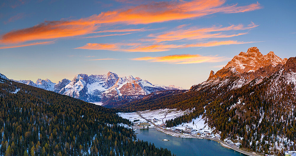 Sunrise over the snowy woods surrounding Lake Misurina and Sorapis, aerial view, Dolomites, Belluno province, Veneto, Italy, Europe