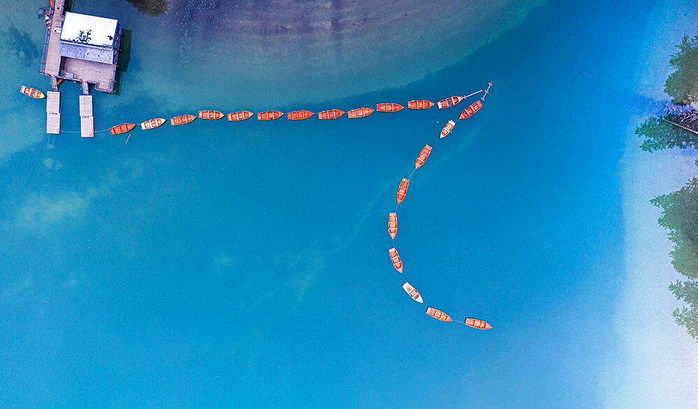 Rowing boats moored in Lake Braies (Pragser Wildsee) from above, Dolomites, South Tyrol, Italy, Europe