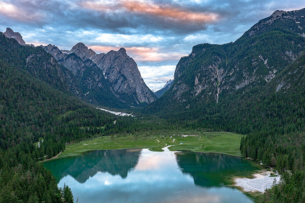 Aerial view of mountains reflected in lake Dobbiaco at sunset, Dobbiaco (Toblach), Dolomites, Bolzano province, South Tyrol, Italy, Europe