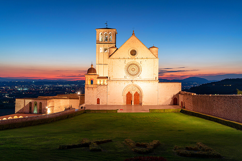 Facade of Basilica di San Francesco d'Assisi, UNESCO World Heritage Site, and gardens at dusk, Assisi, Perugia province, Umbria, Italy, Europe