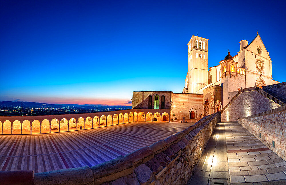 Panoramic of the illuminated arcade and Basilica di San Francesco during blue hour, UNESCO World Heritage Site, Assisi, Perugia province, Umbria, Italy, Europe