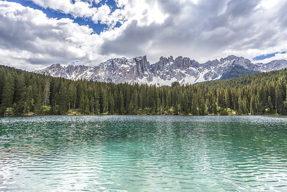 The still deep water of Lake Carezza surrounded by the picturesque frame of the Dolomites, in the Eggental in South Tyrol, Trentinto-Alto Adige, Italy, Europe