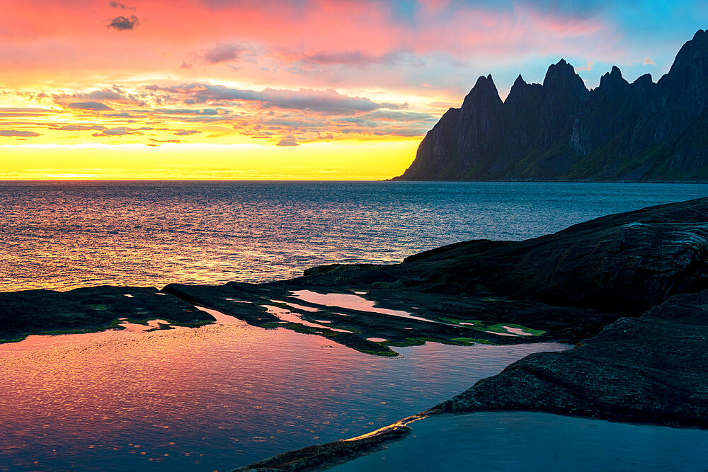 Sharp mountain peaks under the dramatic sky of midnight sun, Tungeneset viewpoint, Senja island, Troms county, Norway, Scandinavia, Europe