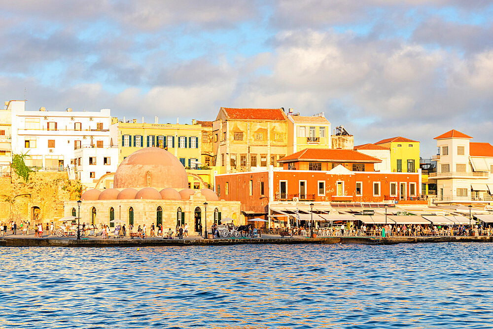 Tourists enjoying sunset at the old Venetian port of Chania, Crete, Greek Islands, Greece, Europe