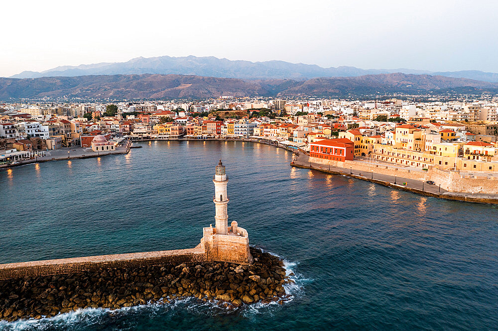 Sunrise over the Venetian lighthouse and harbour in the colorful town of Chania, aerial view, Crete, Greek Islands, Greece, Europe