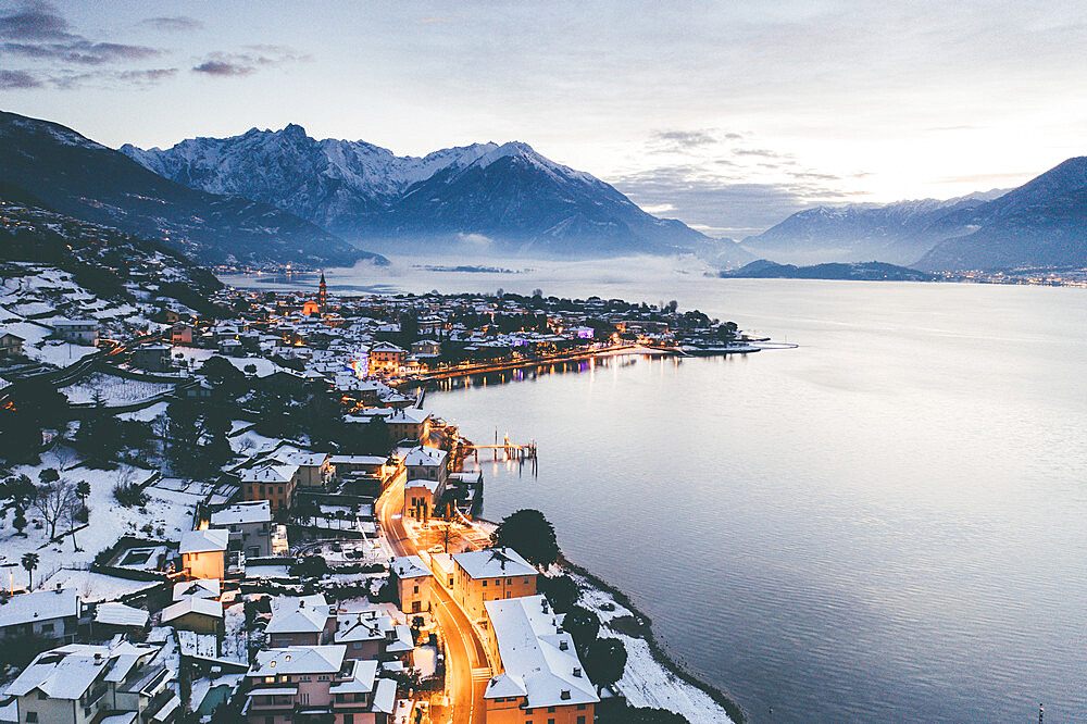 Sunrise over the traditional houses of Domaso covered with snow at Christmas time, Domaso, Lake Como, province of Como, Lombardy, Italian Lakes, Italy, Europe