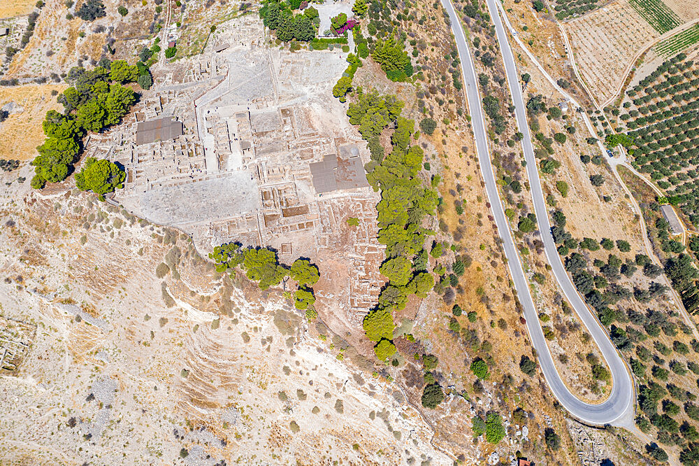 Aerial view of hairpin bends of road near the old ruins of Phaistos Palace and archaeological site, Crete, Greek Islands, Greece, Europe