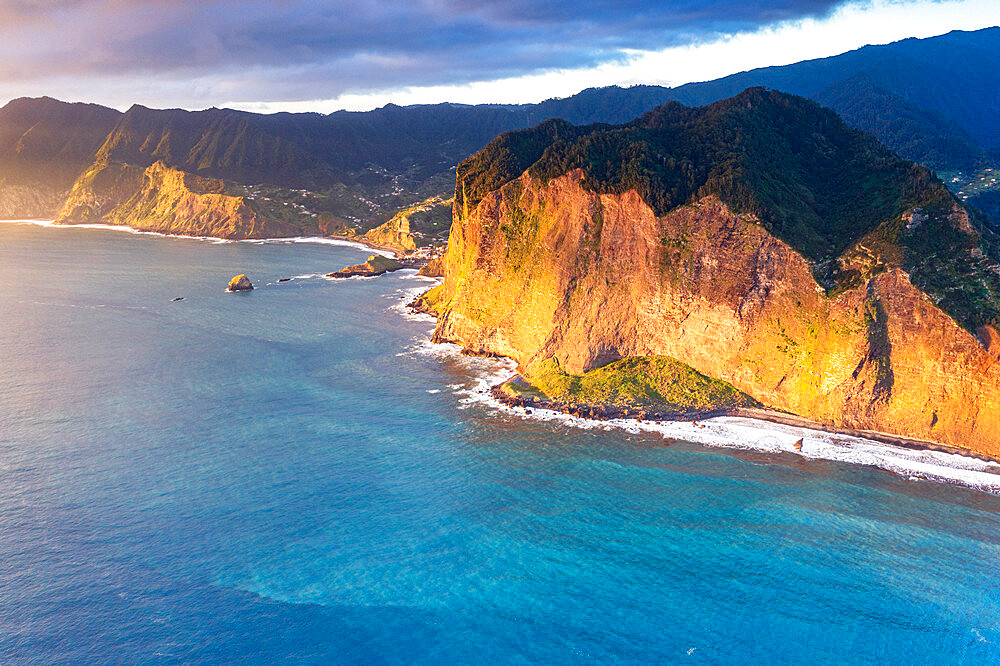 Aerial view of majestic cliffs and coastline at sunrise from Guindaste viewpoint, Faial, Madeira island, Portugal, Atlantic, Europe