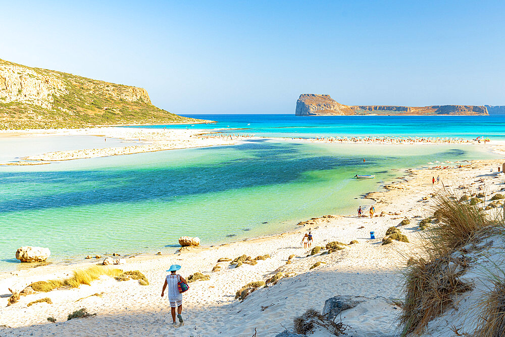 Tourists walking to the white sand beach surrounding Balos lagoon, Crete, Greek Islands, Greece, Europe