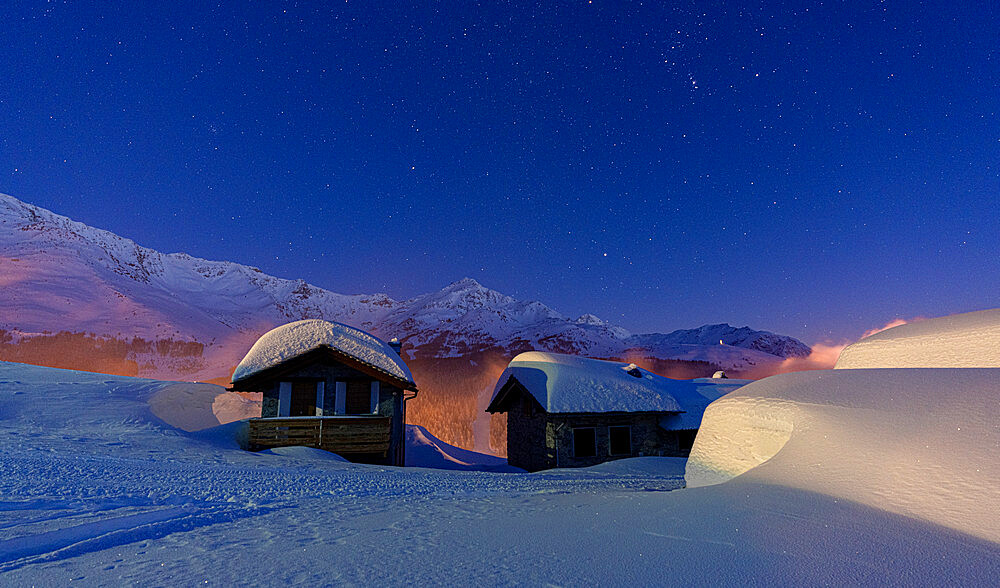 Mountain huts covered with snow during a winter starry night, Andossi, Madesimo, Valchiavenna, Valtellina, Lombardy, Italy, Europe