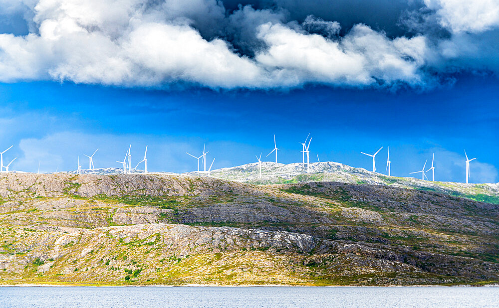 Wind farm of white turbines on rocky coastline, Troms county, Norway, Scandinavia, Europe