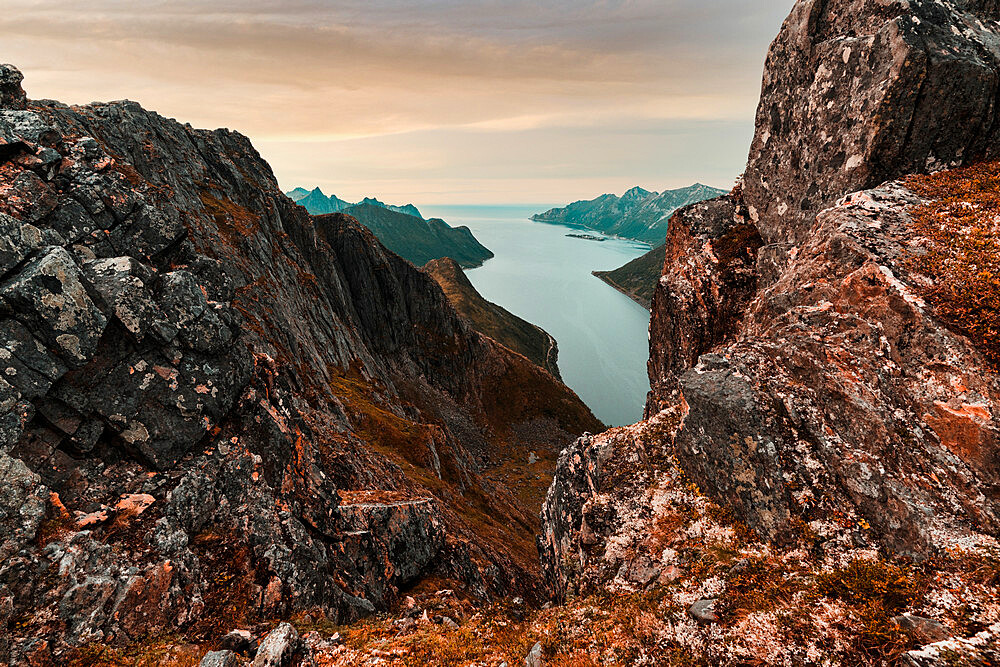 Oyfjorden fjord view from steep hiking trail through red rocks of mountains, Senja island, Troms county, Norway, Scandinavia, Europe