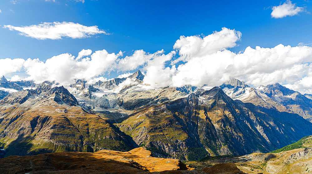 Sun shining over the Zinalrothorn mountain peak through clouds, Valais Canton, Swiss Alps, Switzerland, Europe