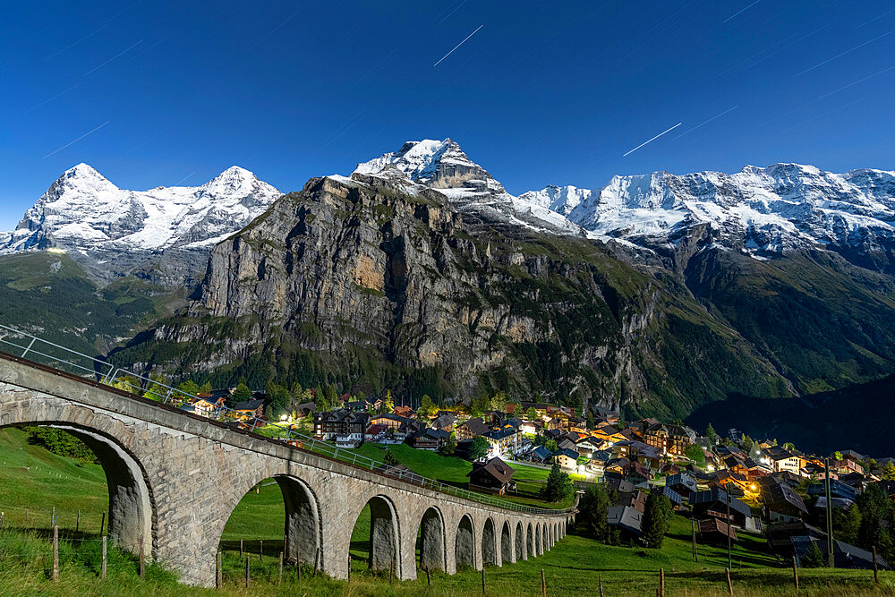 Alpine village of Murren and funicular railway lit by star trail, Lauterbrunnen, Jungfrau Region, Bern Canton, Swiss Alps, Switzerland, Europe