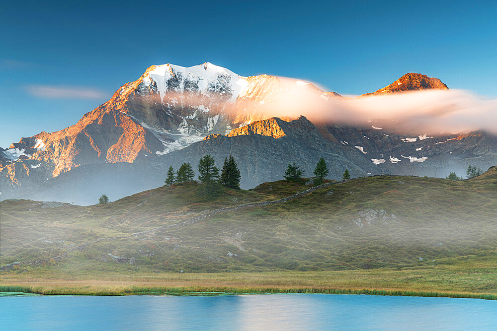 Majestic Fletschhorn and Galehorn peaks in autumn fog at dawn from Hopschusee lake, Simplon Pass, Valais Canton, Swiss Alps, Switzerland, Europe