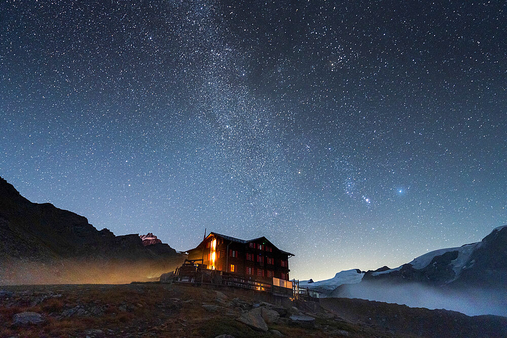 Illuminated mountain hut hotel under the stars, Fluhalp, Zermatt, Valais Canton, Switzerland, Europe