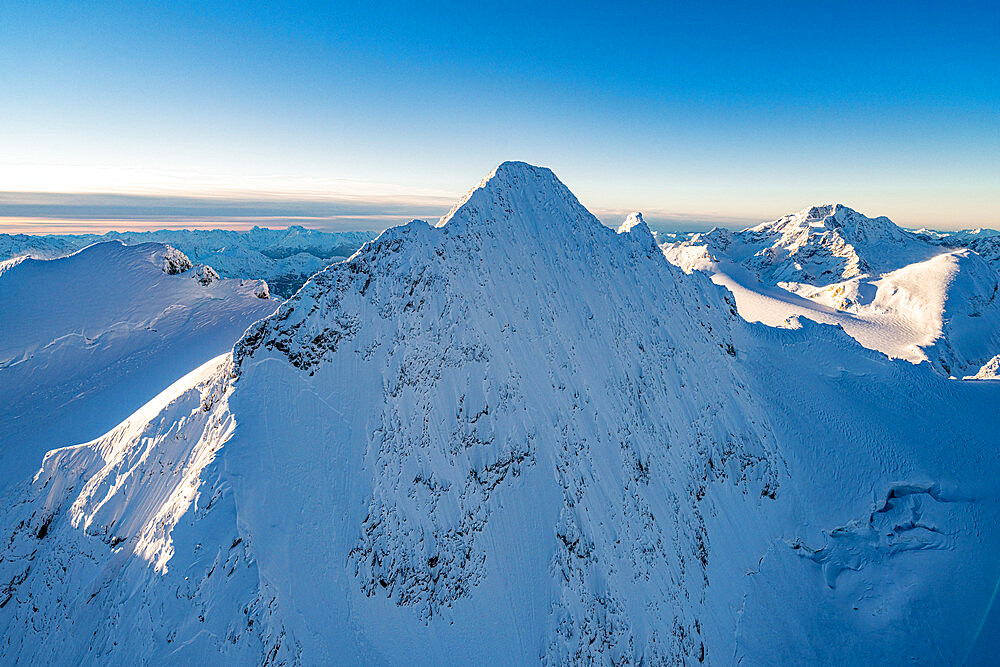 Snowcapped rock face of Monte Disgrazia and Piz Gluschaint in winter, aerial view, Engadine, Graubunden Canton, Switzerland, Europe