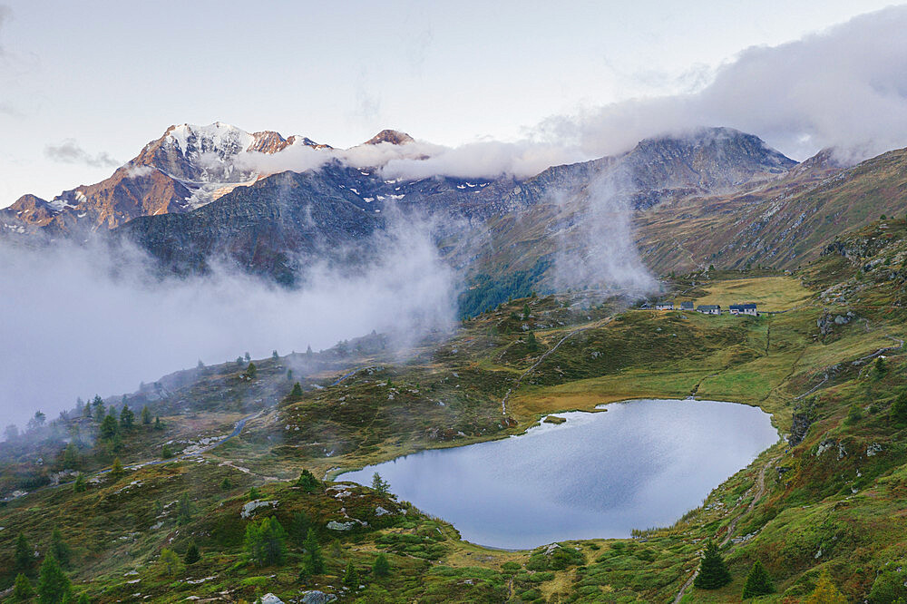 Aerial view of Hopschusee lake with Fletschhorn and Galehorn peaks in mist at sunrise, Simplon Pass, Valais canton, Swiss Alps, Switzerland, Europe