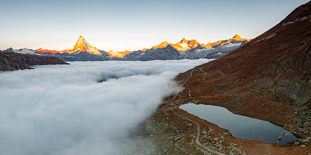 Matterhorn, Dent Blanche, Wellenkuppe and Zinalrothorn peaks in fog from Stellisee lake, Zermatt, Valais canton, Swiss Alps, Switzerland, Europe