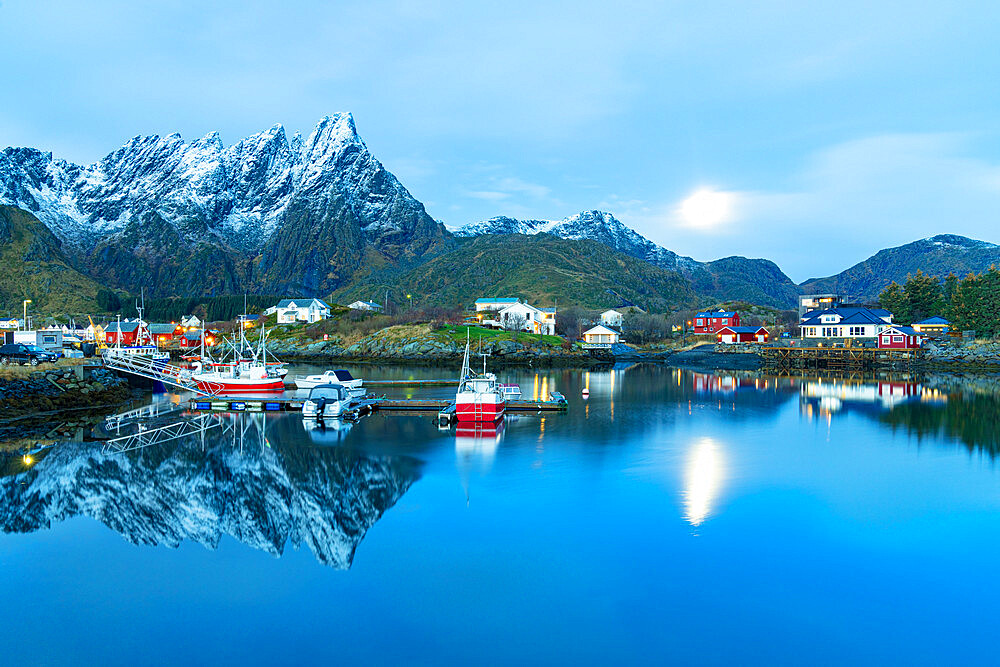 Fishing boats moored in the cold sea at dusk, Ballstad, Vestvagoy, Nordland, Lofoten Islands, Norway, Scandinavia, Europe