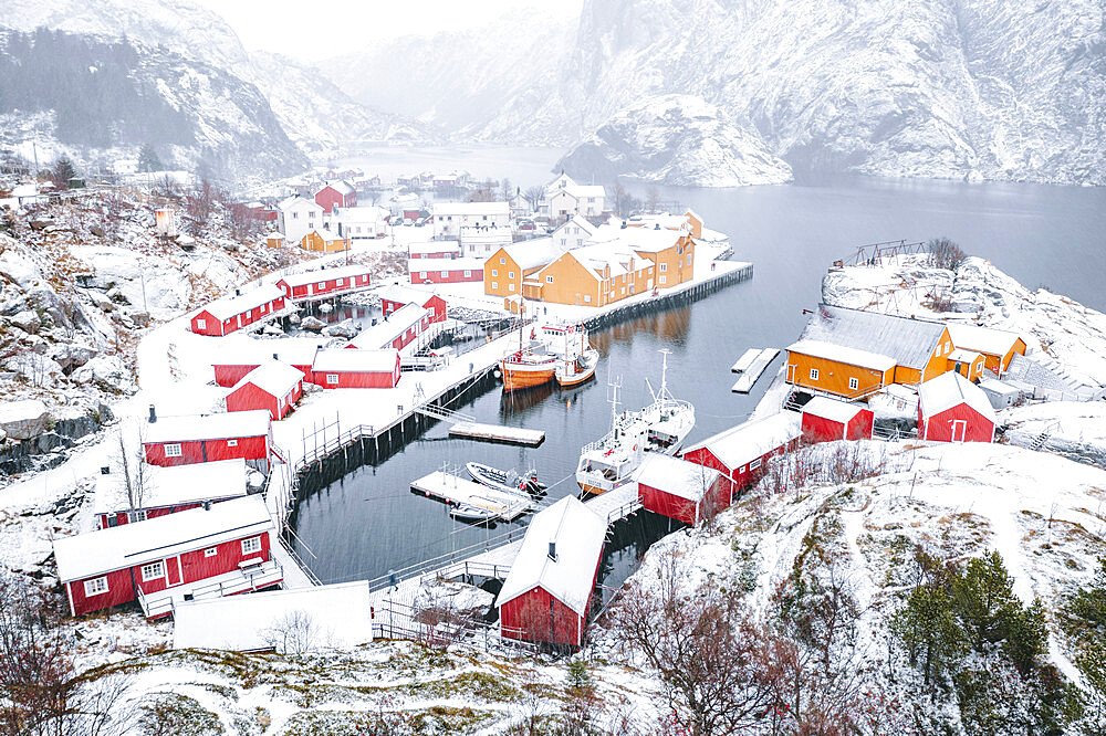 High angle view of traditional fishermen's cabins and harbor covered with snow, Nusfjord, Nordland, Lofoten Islands, Norway, Scandinavia, Europe