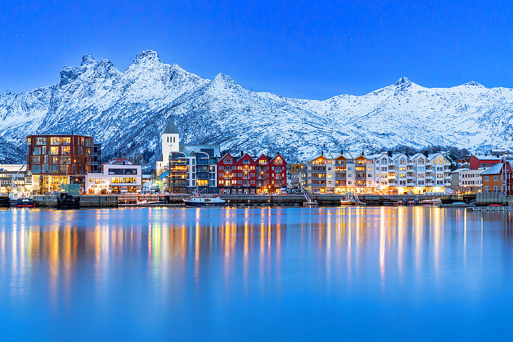 Coastal town of Svolvaer framed by snowcapped mountains at dusk, Nordland county, Lofoten Islands, Norway, Scandinavia, Europe