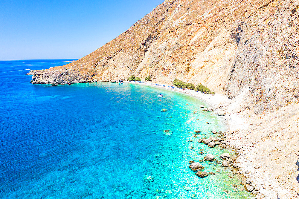 Aerial view of the scenic Glyka Nera beach by the crystal turquoise sea, Hora Sfakion, Crete island, Greek Islands, Greece, Europe