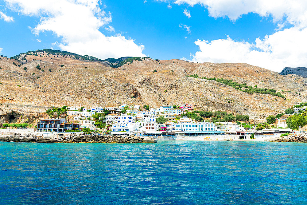 Seaside town resort of Hora Sfakion view from boat trip in the blue sea, Crete island, Greek Islands, Greece, Europe