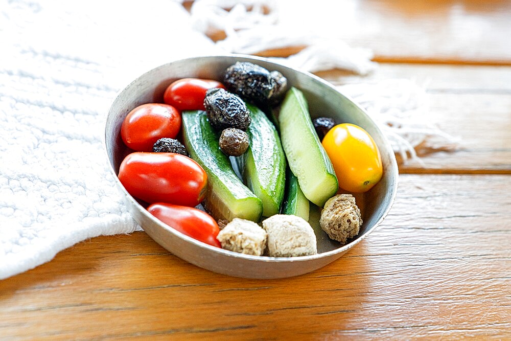 Fresh tomatoes and cucumbers in a bowl, main ingredients of the Greek cuisine, Crete island, Greek Islands, Greece, Europe