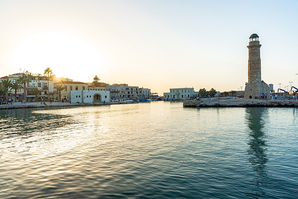 Sunset over the medieval town of Rethymno and old lighthouse, Crete island, Greek Islands, Greece, Europe