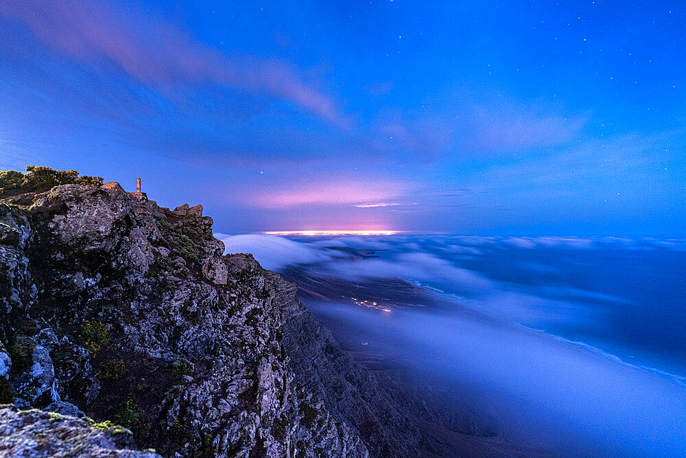 Starry sky over majestic Pico de la Zarza mountain peak covered by night fog, Fuerteventura, Jandia, Canary Islands, Spain, Atlantic, Europe