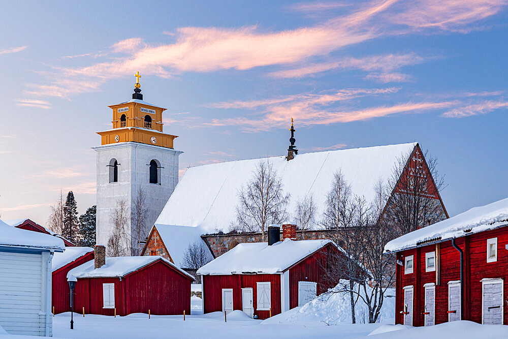 Old church and picturesque buildings covered with snow at sunset in Gammelstad old town, UNESCO World Heritage Site, Lulea, Sweden, Scandinavia, Europe