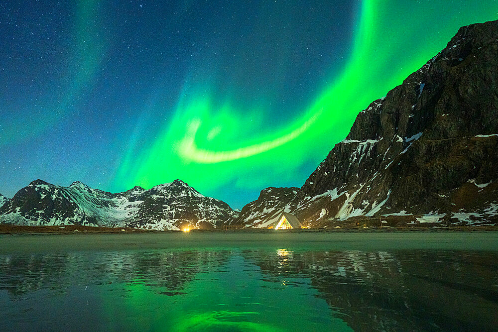 Glass igloo on Skagsanden beach under the Aurora Borealis (Northern Lights), Flakstad, Lofoten Islands, Norway, Scandinavia, Europe